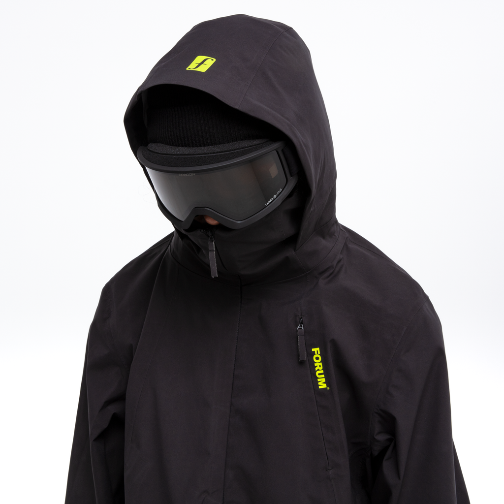 Forum snowboard 3 layer all-mountain jacket model hood front in black.